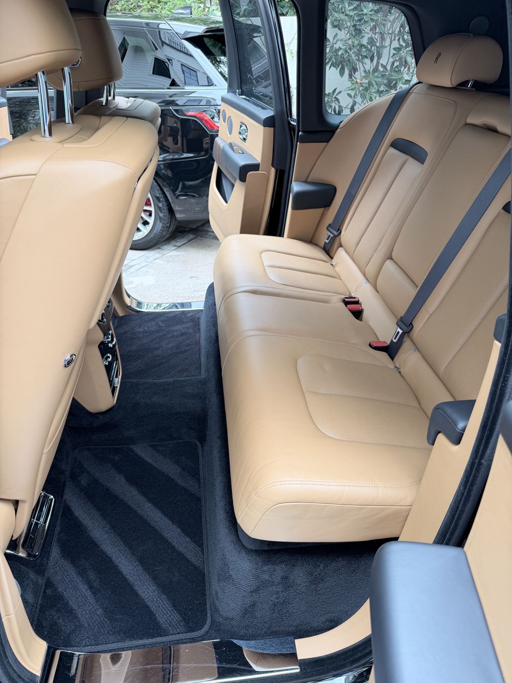 Spotless tan leather rear seats and fresh carpet lines